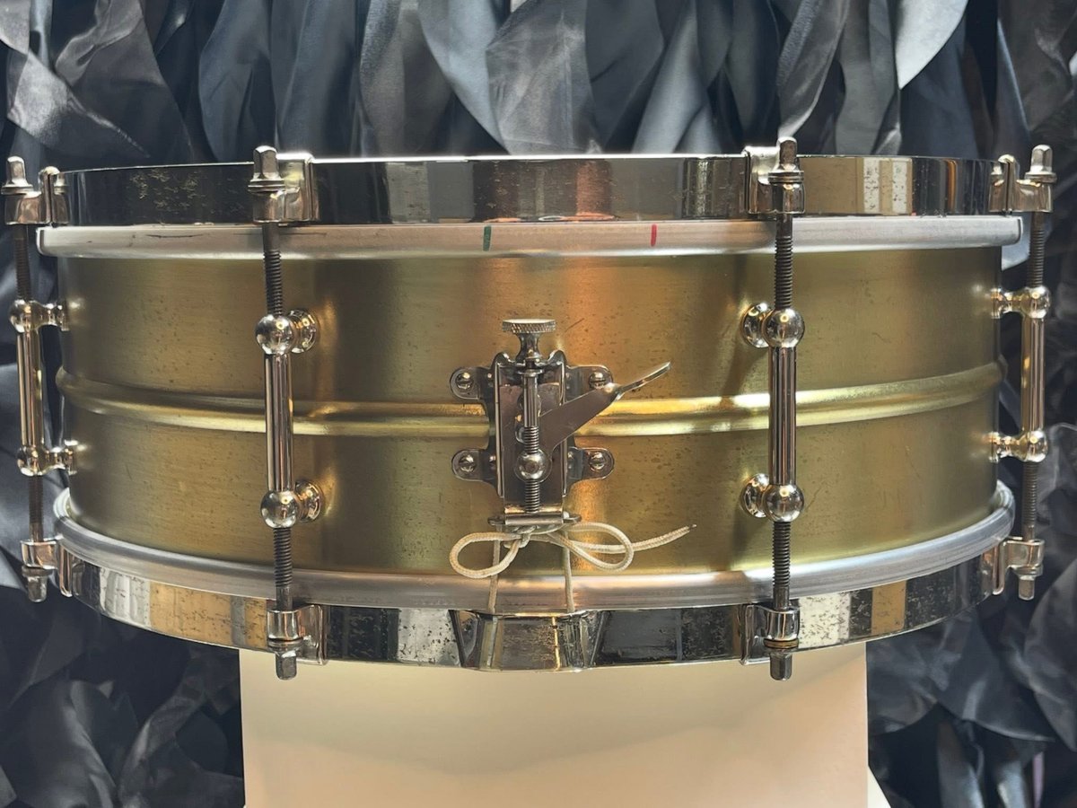 Vintage brass-shell snare drum with nickel tube lugs and single-flange hoops