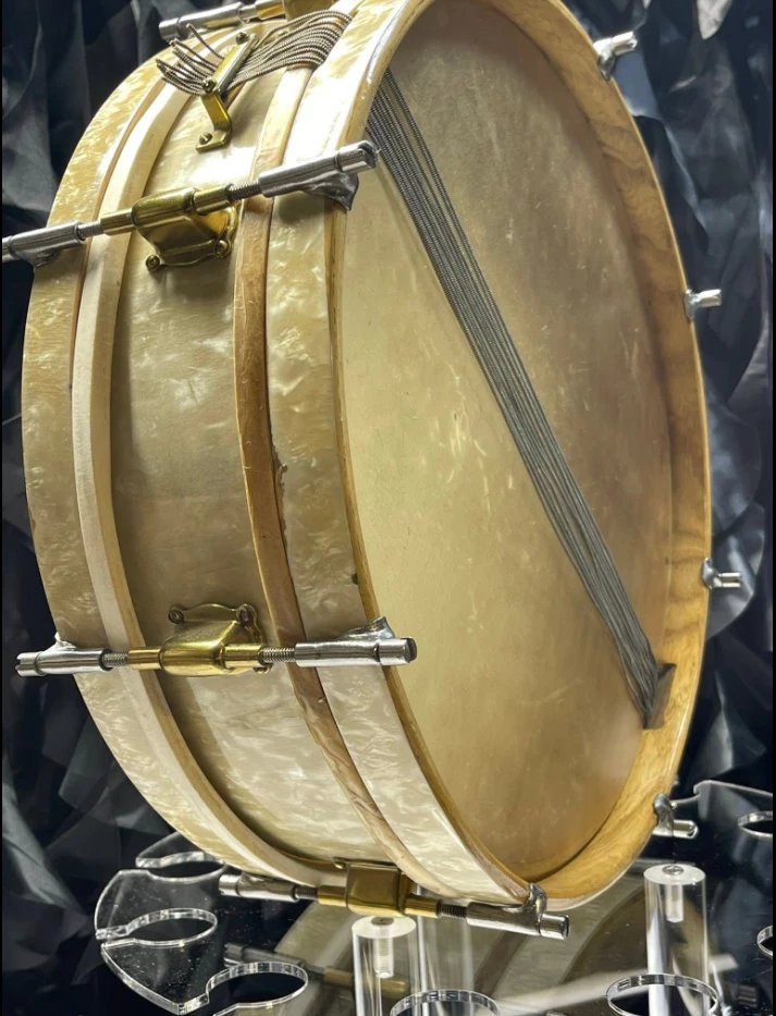 Jedson De Luxe snare drum resonant side, showing the wire snares across the calfskin head and the strainer