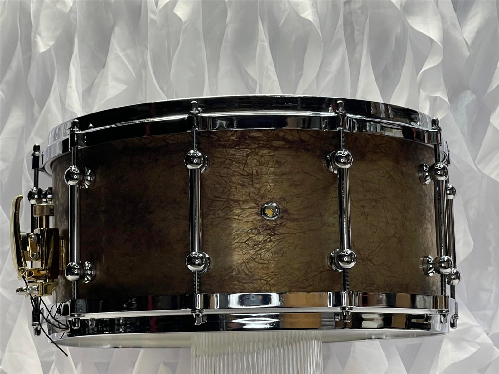 Custom 14x6.5 2mm patina brass snare drum with aluminum die-cast rims and gold strainer