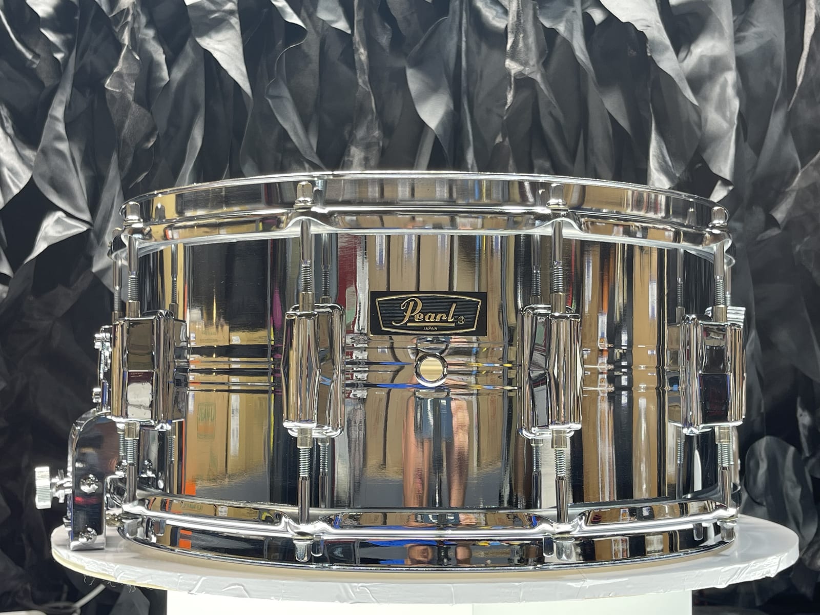 1976 Pearl Jupiter 14x6.5 chrome-over-brass snare, front view, showing the Pearl badge and center bead